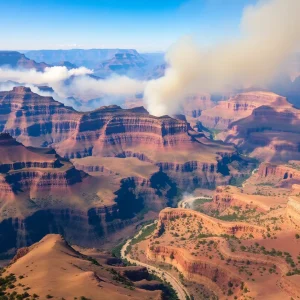Aerial view of the Grand Canyon impacted by wildfires with smoke and damaged vegetation.