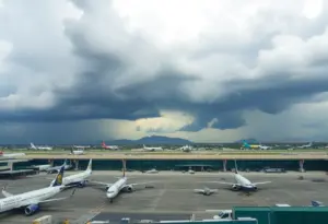 Cloudy skies over Sky Harbor Airport with planes on the tarmac.