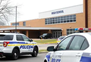 Exterior view of Queen Creek High School during a police investigation.