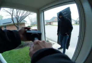 Doorbell camera footage of an armed intruder at a couple's home
