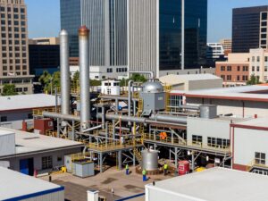 Mesa showcasing a bustling industrial landscape with factories and workers.