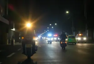 Scene of a motorcycle incident in Phoenix at night with police lights