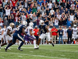 Energetic college sports event in Arizona with athletes and spectators.