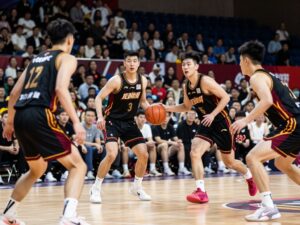 Arizona State Sun Devils basketball players wearing new black jerseys with maroon and gold accents during a game.