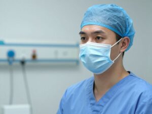 A healthcare professional wearing a mask during flu season in a hospital.