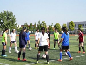 Girls soccer team practicing on a field