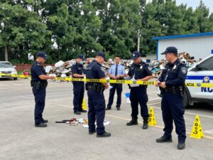 Police officers investigating a recycling facility for evidence in a missing person's case.