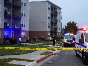Scene of a shooting incident at an apartment complex with police presence