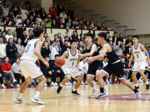 Players competing in a high school basketball game, showcasing teamwork and enthusiasm.