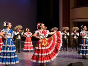 Performers at the Phoenix Mariachi & Folklórico Festival showcasing vibrant costumes and traditional music.