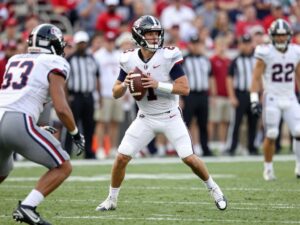 Exciting college football game with a quarterback in action.