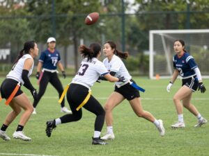 Women playing flag football on the field at Arizona Christian University