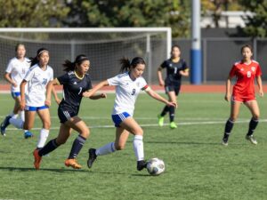 High school girls soccer playoffs in Arizona featuring energetic players on the field.