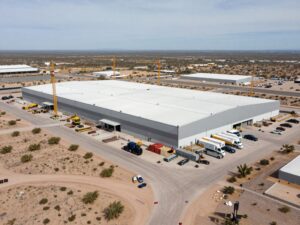 Construction site of the new DSV regional headquarters in Mesa, Arizona, showing a large industrial building being developed.