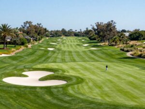 A vibrant golf course with players enjoying a sunny day at Foothills Golf Club.