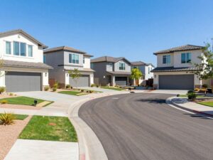 Street view of modern, single-story build-to-rent homes with private yards in a Phoenix AZ suburban neighborhood.