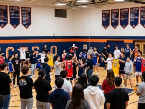 Perry High School gymnasium with crowd celebrating jersey retirement