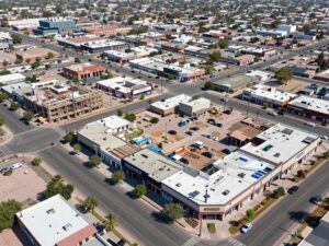 Aerial view of commercial retail development in Phoenix, Arizona, showing new construction and existing businesses.