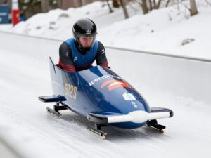 Athlete representing Team Canada training for bobsleigh in snowy conditions.