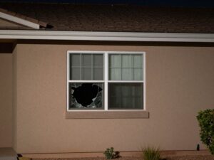 Exterior of a Tempe, Arizona apartment building with a broken window, indicative of a break-in.