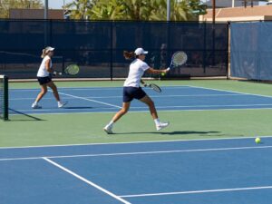 Players from the University of Hawai'i competing in a tennis match at GCU Tennis Facility in Phoenix.